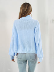 Pastel blue ribbed knit zip-up sweater with a mock neck and long sleeves.