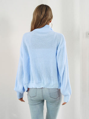 Pastel blue ribbed knit zip-up sweater with a mock neck and long sleeves.