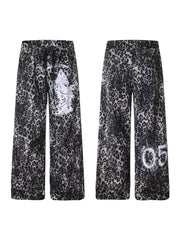 Leopard print cotton sweatpants with drawstring waist and wide legs, featuring graphic print details.
