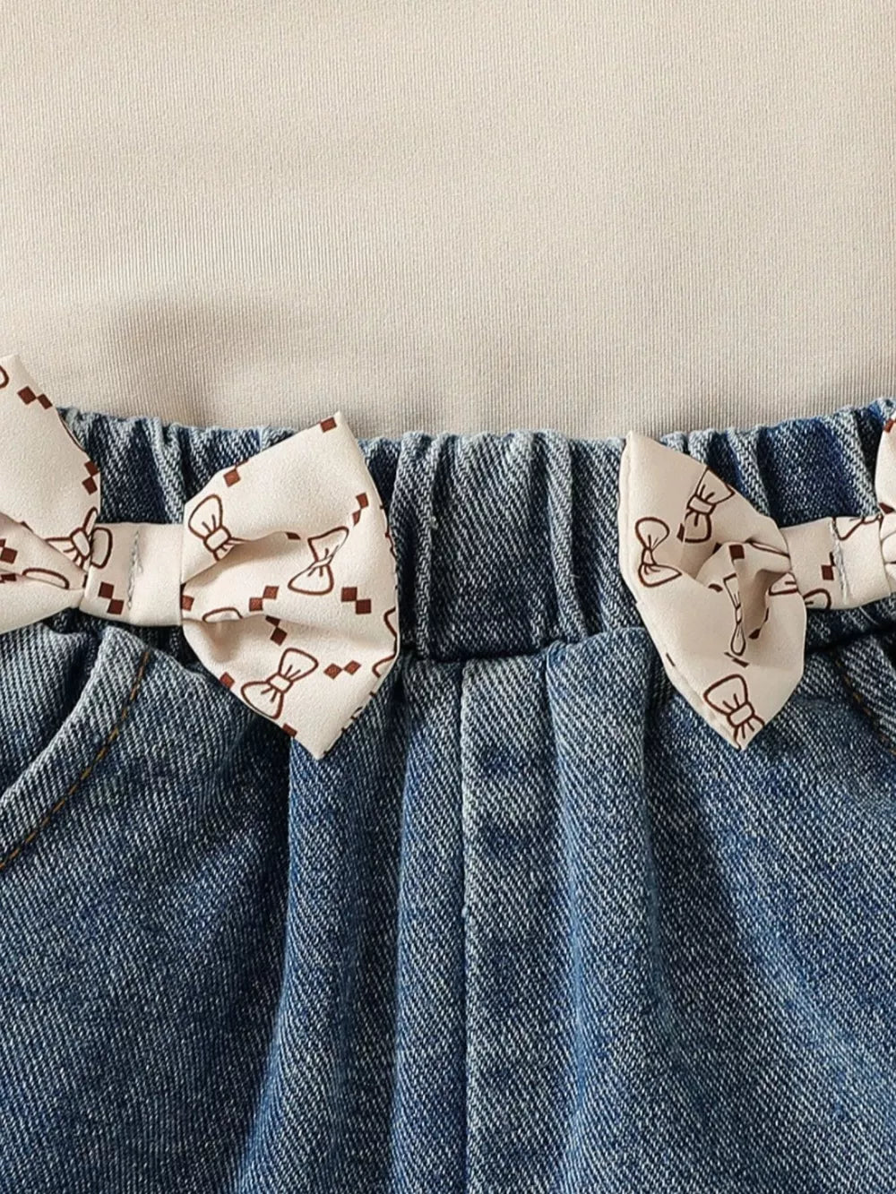 Baby denim shorts with bow print trim and elastic waistband.
