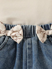 Baby denim shorts with bow print trim and elastic waistband.