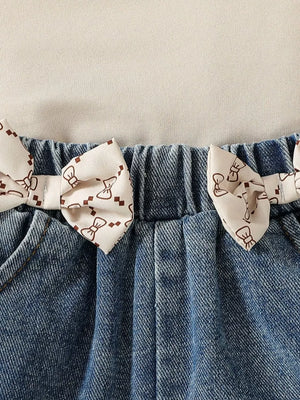 Baby denim shorts with bow print trim and elastic waistband.