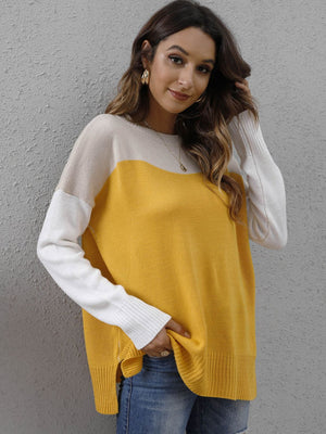 Colorblock crewneck knit sweater in yellow, cream, and white with side slits.