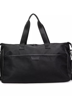 Black Oxford cloth travel duffle bag with top handles and front pocket detail.