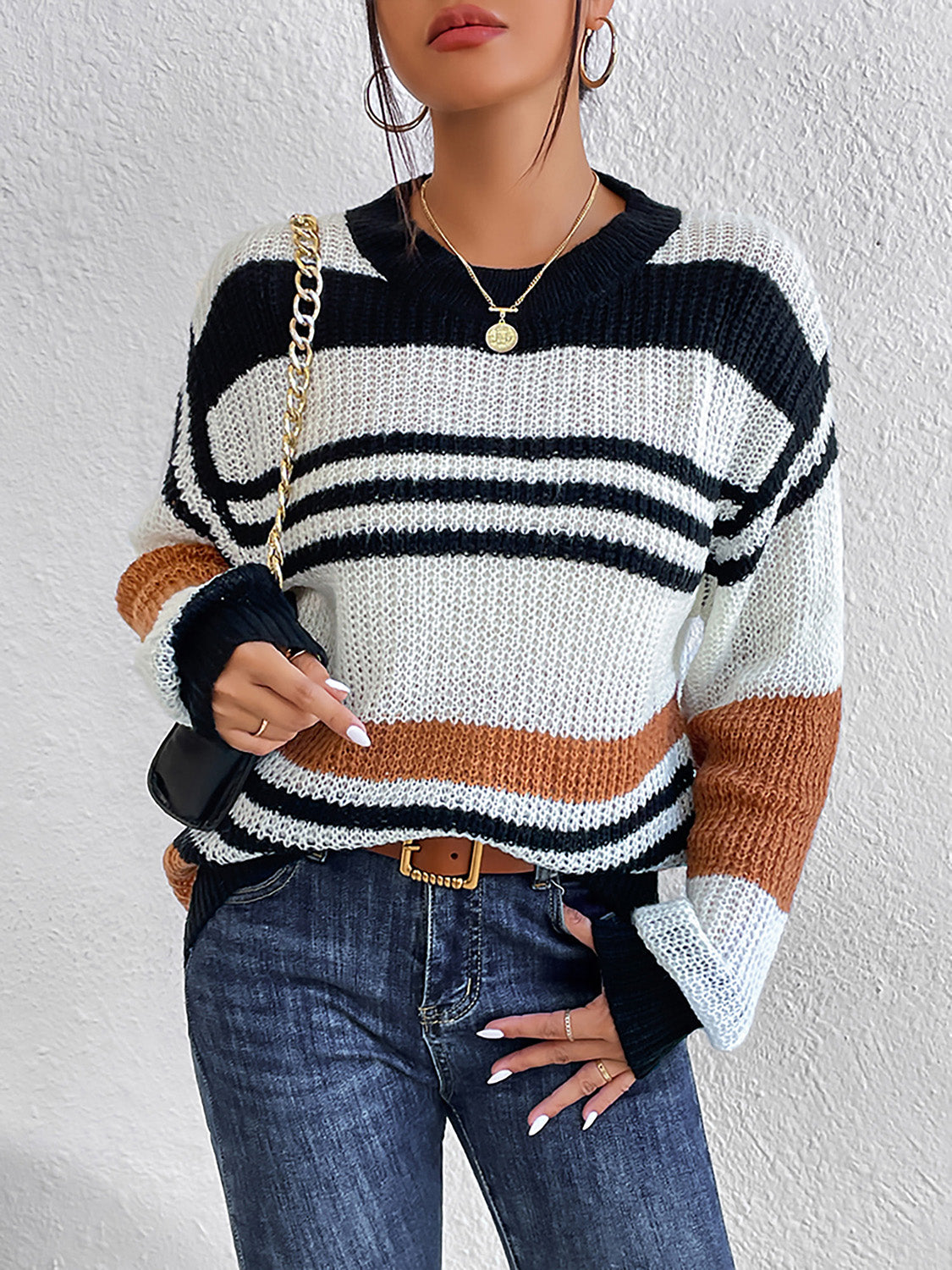 Colorblock stripe knit crewneck sweater in caramel, black, and white acrylic with a relaxed fit.