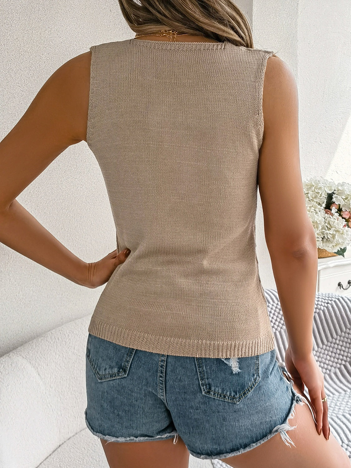 Tan openwork knit tank top with a square neckline and sleeveless design.