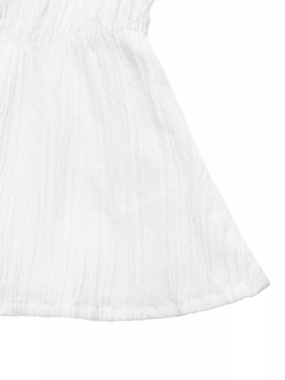 White textured maternity blouse with a cinched empire waist and flared hem.