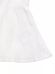 White textured maternity blouse with a cinched empire waist and flared hem.