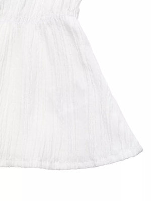 White textured maternity blouse with a cinched empire waist and flared hem.