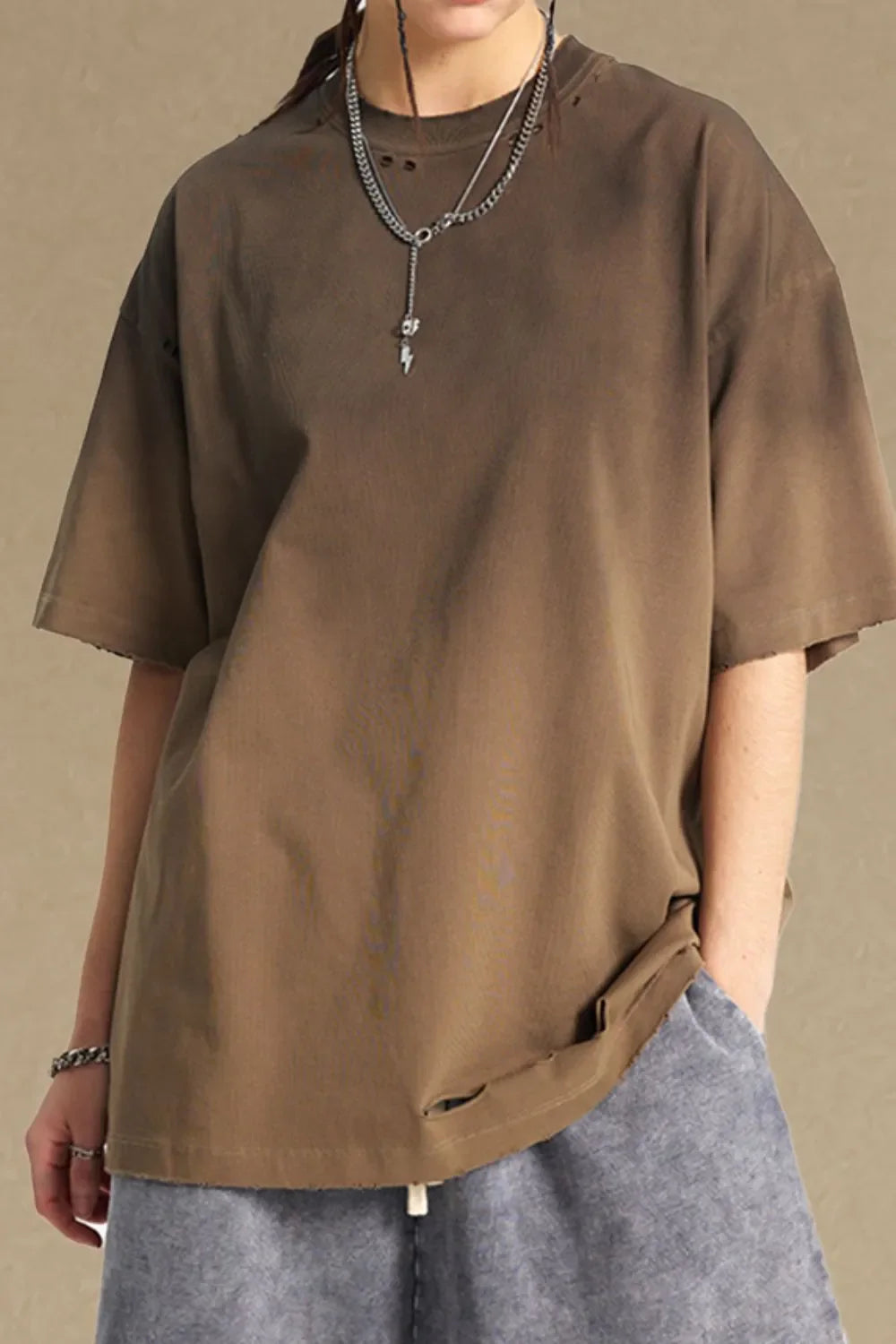 Taupe oversized t-shirt with distressed neckline and hem, short sleeves.