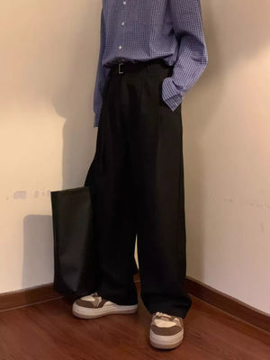 Black wide-leg sweatpants with a belted waist and D-ring detail.