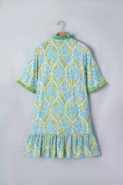 Mini dress with blue floral pattern, ruffle hem, and green trim.