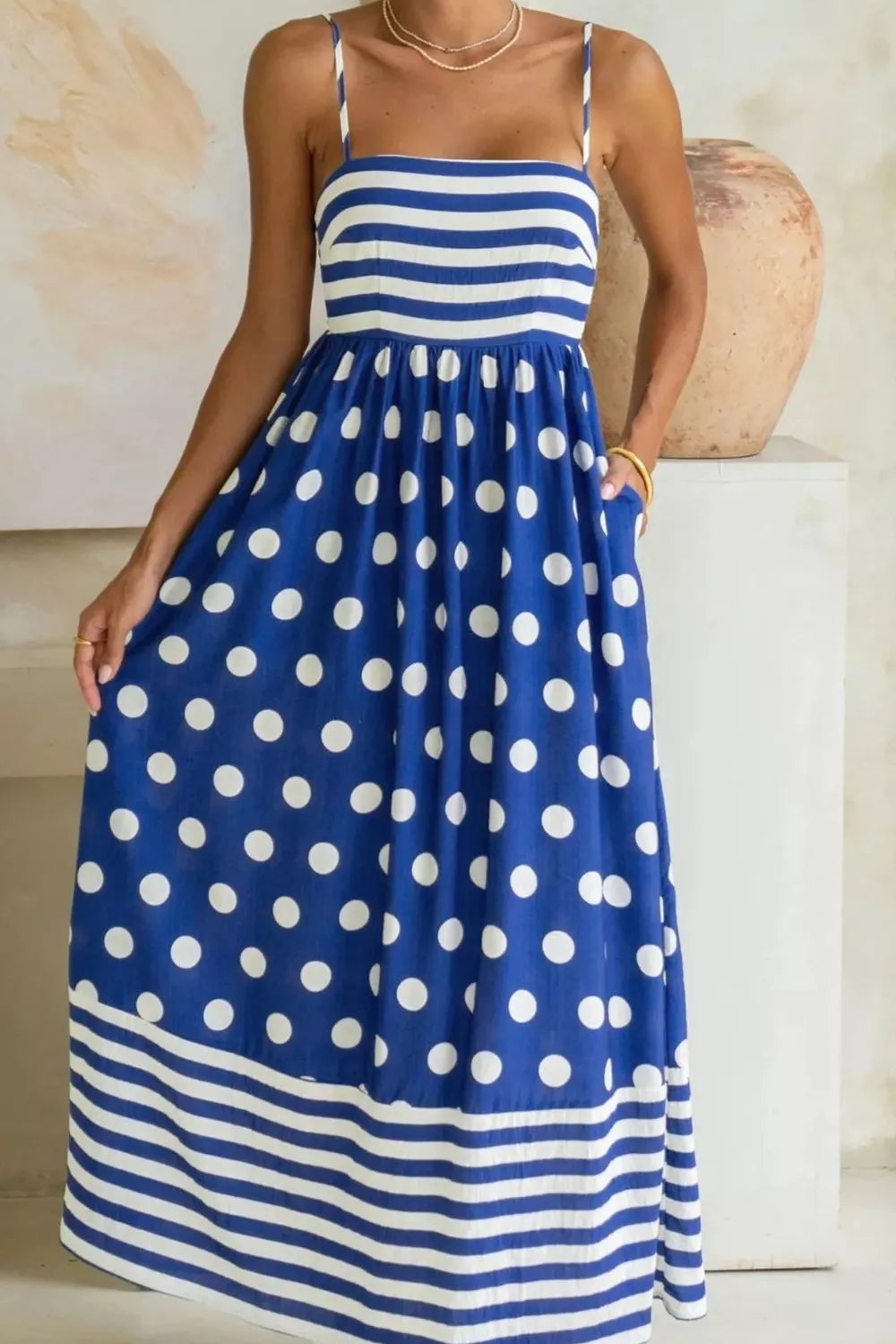 Playful patchwork maxi swim dress with spaghetti straps, blue with white polka dots and stripes, pockets.