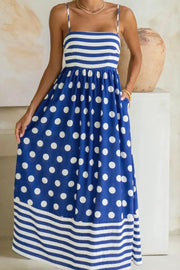 Playful patchwork maxi swim dress with spaghetti straps, blue with white polka dots and stripes, pockets.