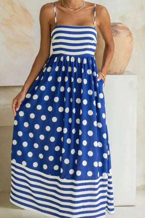 Playful patchwork maxi swim dress with spaghetti straps, blue with white polka dots and stripes, pockets.