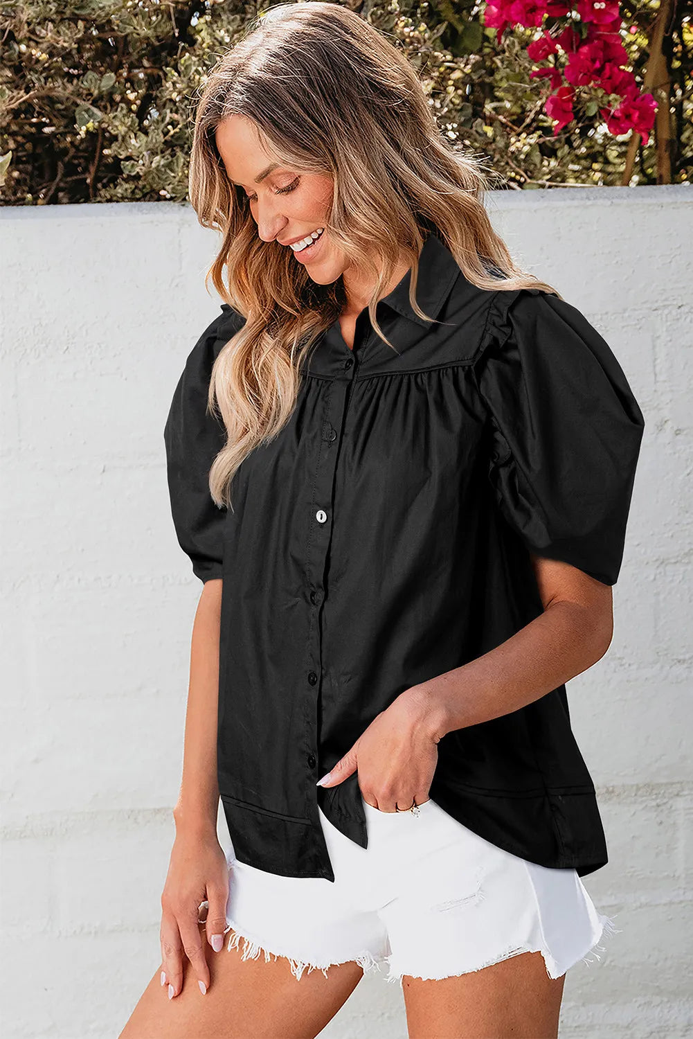Black poplin blouse with gathered short puff sleeves and button front.