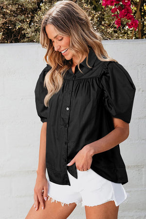 Black poplin blouse with gathered short puff sleeves and button front.
