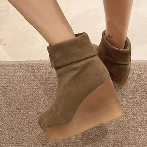 Brown suede wedge boots with a folded cuff detail.