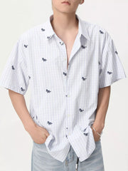 Embroidered animal plaid short sleeve button up shirt in white and blue with a casual fit.