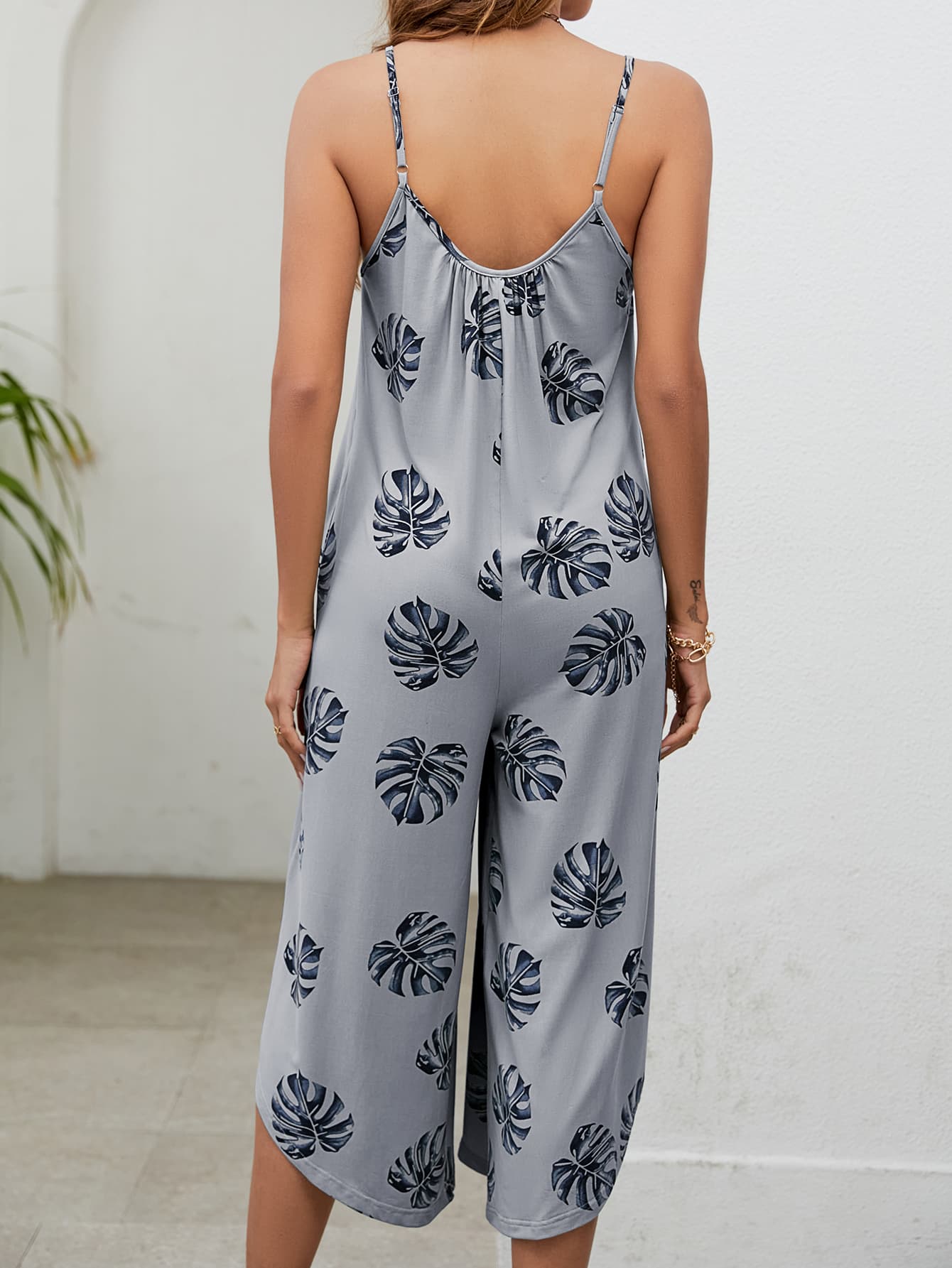 Monstera print culotte jumpsuit in Gray Dawn with gathered bust and spaghetti straps.