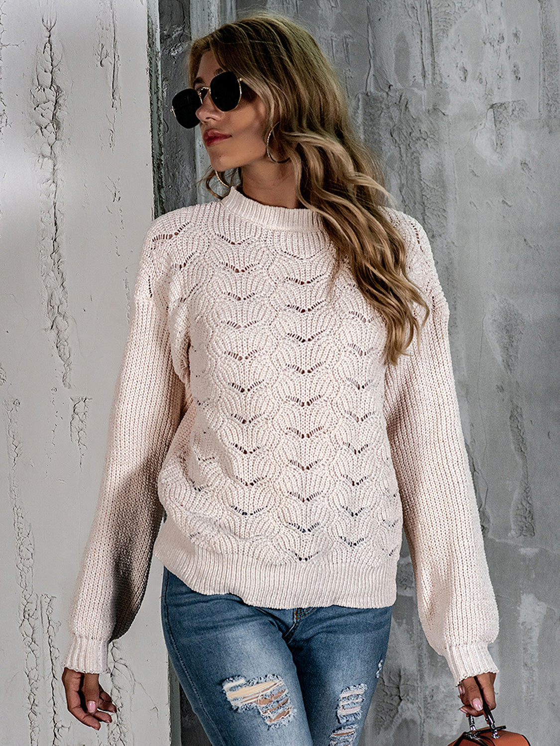 Openwork knit crew neck pullover sweater in blush pink with balloon sleeves.