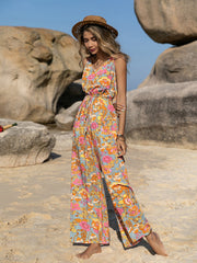 Bohemian floral jumpsuit with tie straps, V-neck, elastic waist, and wide legs.