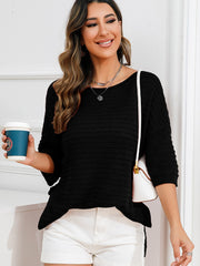 Black textured knit sweater with boat neck and slit hem