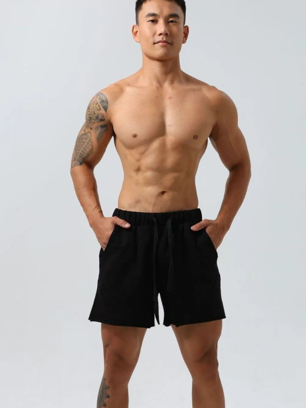 Black lounge shorts with raw-edge seam detail and drawstring waist.