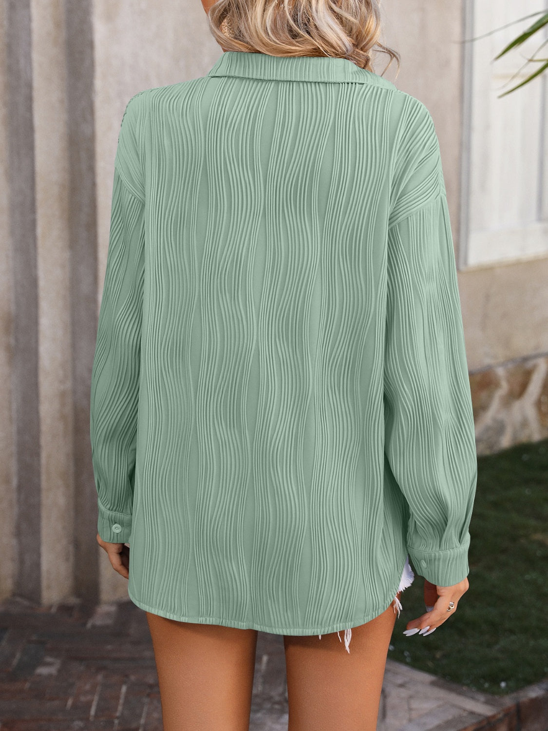 Sage green textured pleat oversized button-down shirt with long sleeves.