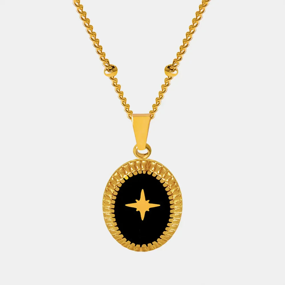 Gold celestial starburst oval pendant necklace with black inlay