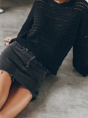 Black open-knit sweater with bell sleeves and a relaxed fit.