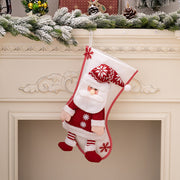 Plush Santa Christmas stocking with red knit sweater and hat, white beard, and striped pants.
