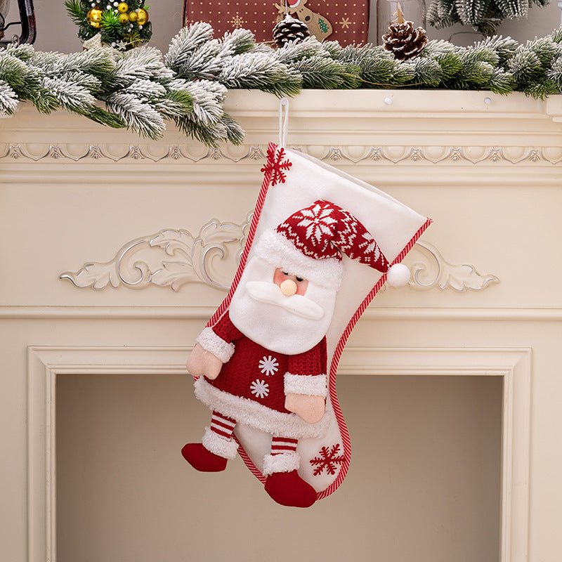 Plush Santa Christmas stocking with red knit sweater and hat, white beard, and striped pants.