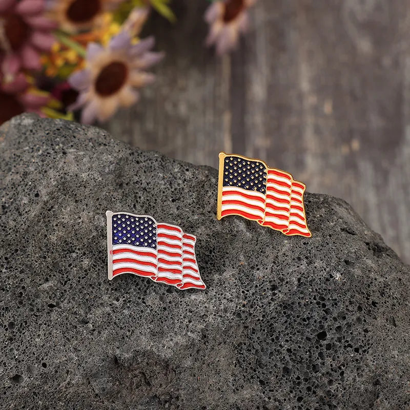 Waving flag enamel pins with American flag design and gold or silver tone borders.