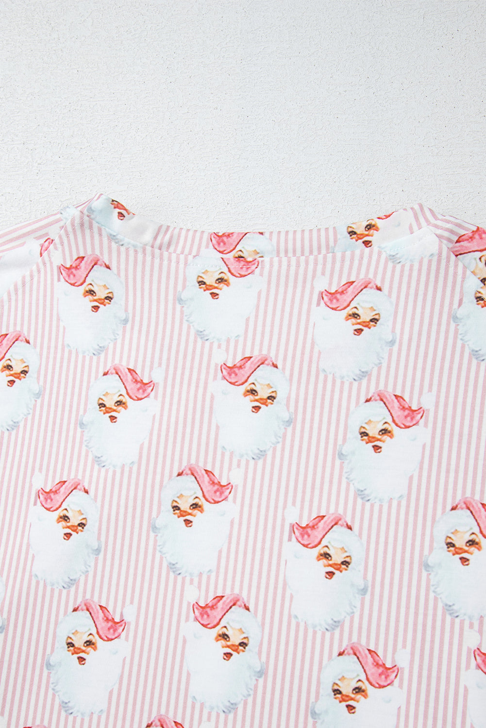 Blush pink striped loungewear set with a repeating Santa Claus print.