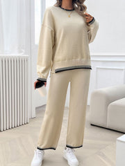 Beige knit lounge set with black ribbed trim on neckline, cuffs, and hem.