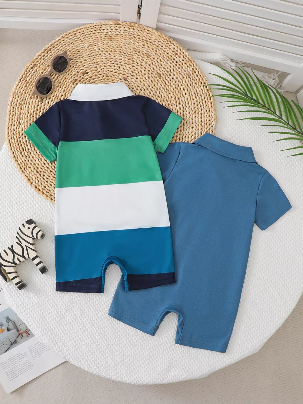 Color block polo romper for kids with navy, green, white, and blue stripes.