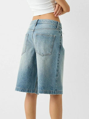 Culotte-cut denim bermuda shorts in dusty blue with a raw hem.