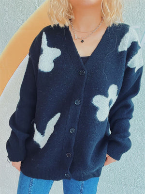 Black acrylic cardigan with playful white floral appliqué and buttons.