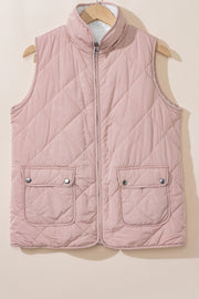 Blush pink quilted sherpa-lined utility vest with snap-flap pockets and a stand collar.