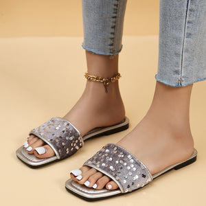 Sequined open-toe flat sandals in silver with a comfortable slip-on design.
