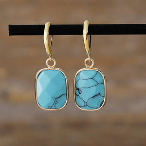 Turquoise stone drop earrings with gold plating and unique veining detail.