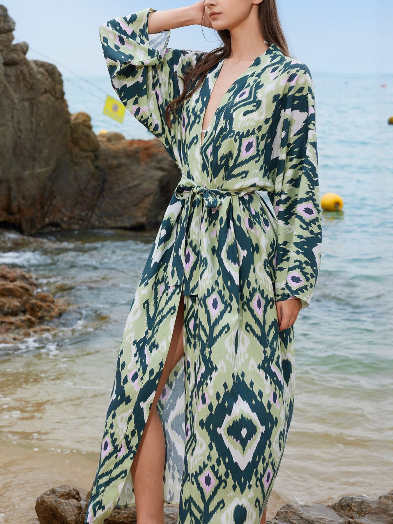 Boho print maxi beach cover-up in green with a V-neck, long sleeves, and a tie waist.