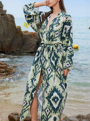 Boho print maxi beach cover-up in green with a V-neck, long sleeves, and a tie waist.