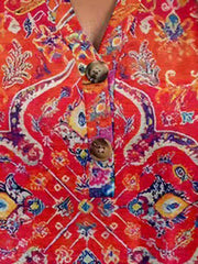 Americana Henley top in Orange-Red with a vibrant paisley print and button detail.