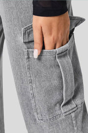 Utility denim wide-leg cargo pants in gray, showing a hand in the pocket.