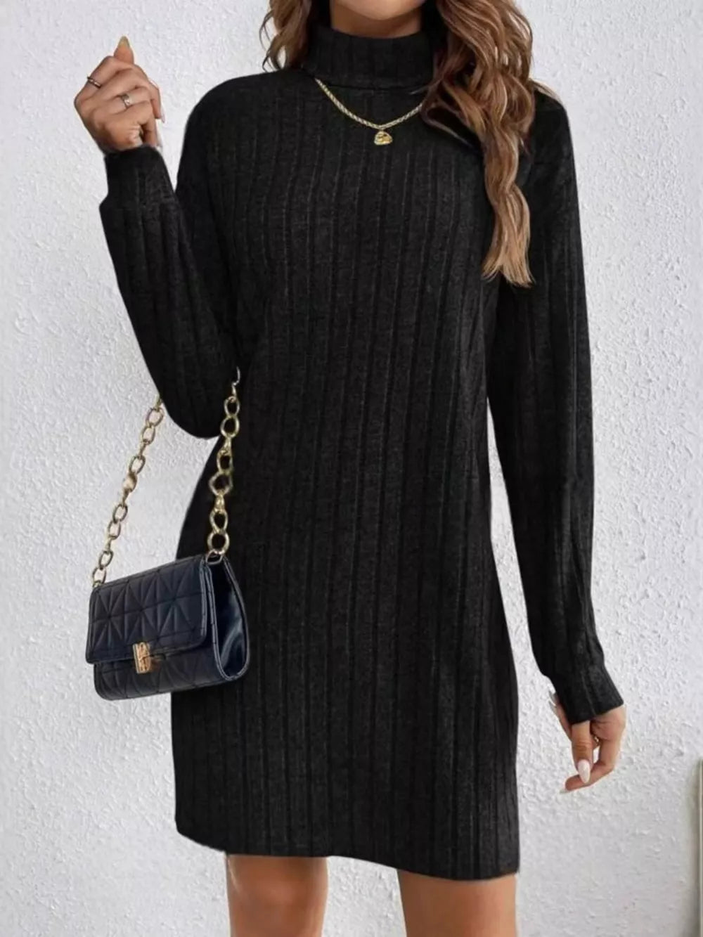 Black ribbed turtleneck mini dress with long sleeves and a casual cut.