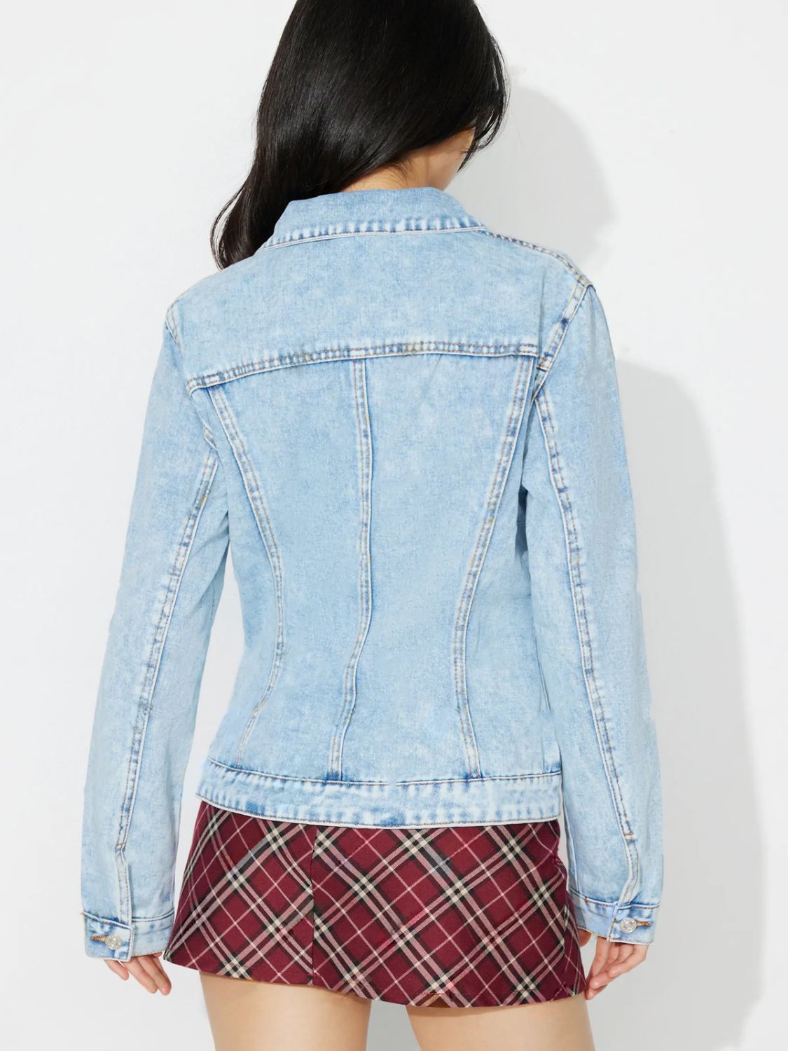 Light wash denim jacket with classic details and buttoned cuffs.