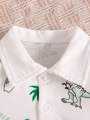 White baby polo shirt with dinosaur print and green palm trees, featuring a collar and button placket.