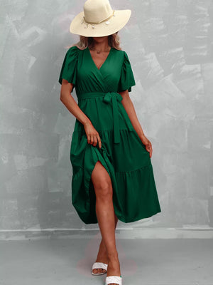 Dark green tiered midi dress with flutter sleeves, V-neck, and belted waist.
